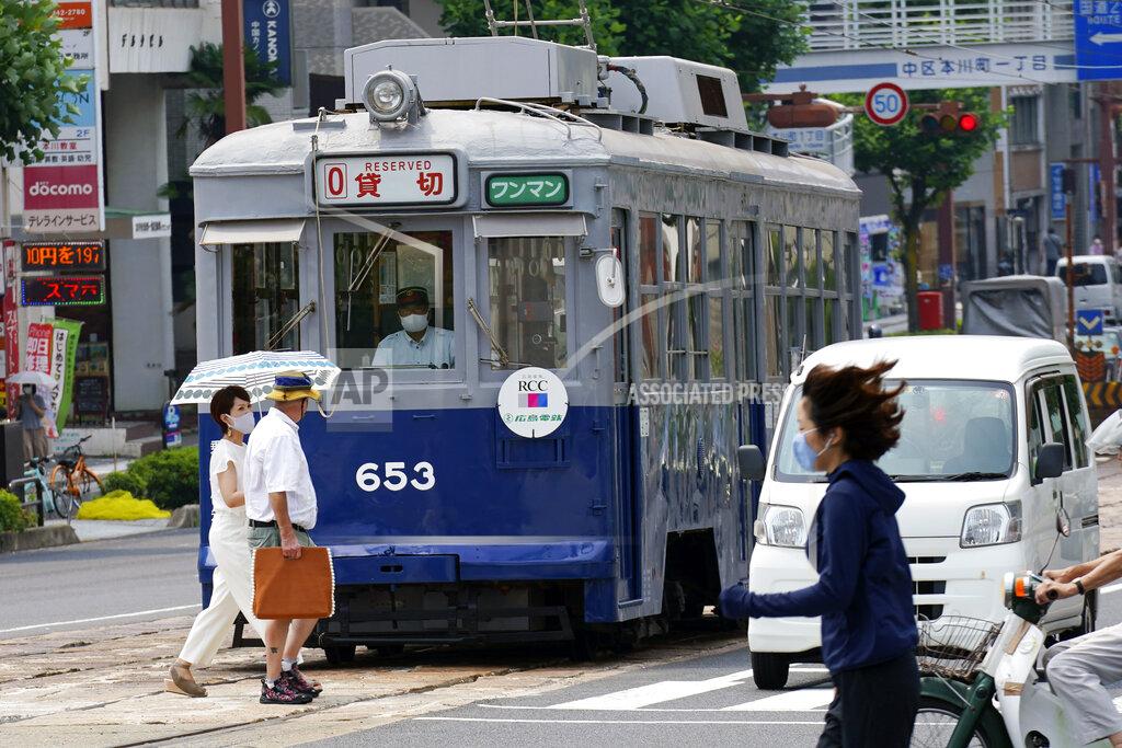 Eugene Hoshiko The No. 653 tram, which survived the atomic bomb, runs along the street near the Atomic Bomb Dome to commemorate the 75th anniversary of the U.S. first atomic bombing on the city in Hiroshima, Japan, Thursday, Aug. 6, 2020. (AP Photo/Eugene Hoshiko)