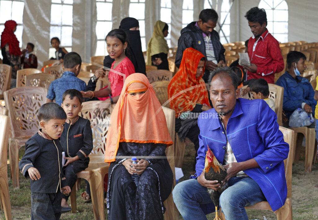 Uncredited Rohingya refugees wait to be transported on a naval vessel to Bhashan Char, or floating island, in the Bay of Bengal, from Chittagong, Bangladesh, Friday, Dec. 4, 2020. Authorities in Bangladesh on Friday started sending a first group of nearly more than 1,500 Rohingya refugees to an isolated island despite calls by human rights groups for a halt to the process. (AP Photo).