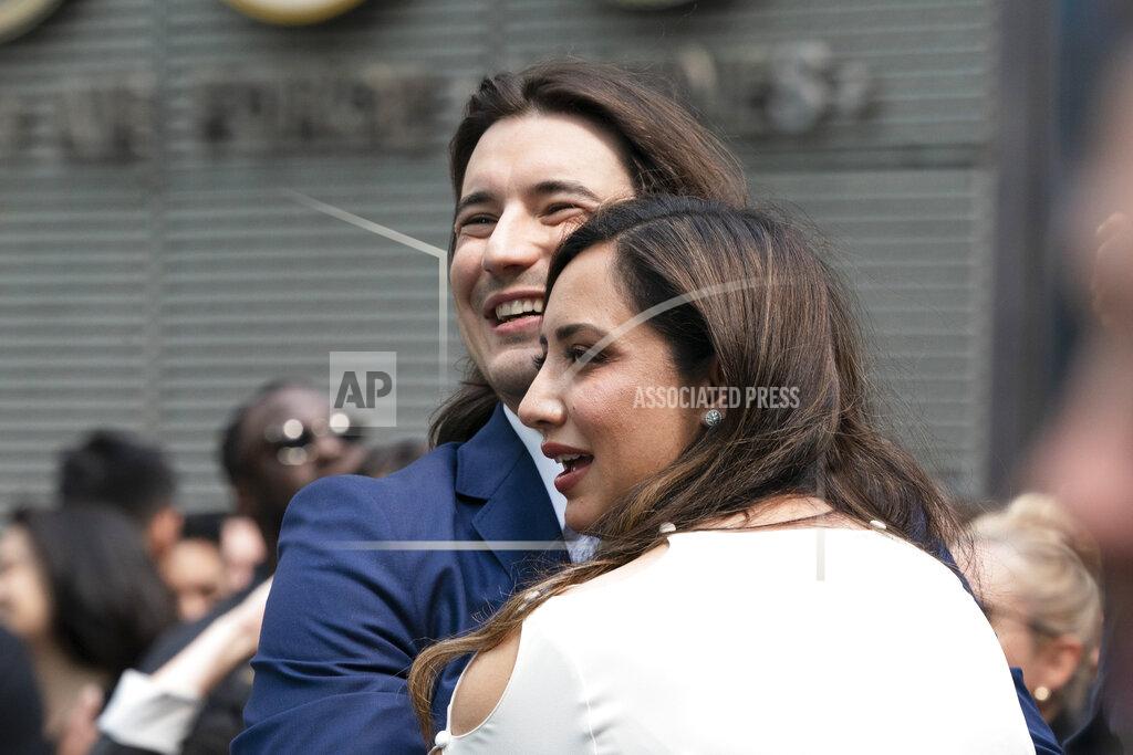 Mark Lennihan Vladimir Tenev, CEO and co-founder of Robinhood, embraces his wife Celina in New York's Times Square following his company's IPO, Thursday, July 29, 2021. Robinhood has already changed how people trade stocks and who's doing it. Now its sights are on the rest of the financial industry. (AP Photo/Mark Lennihan)