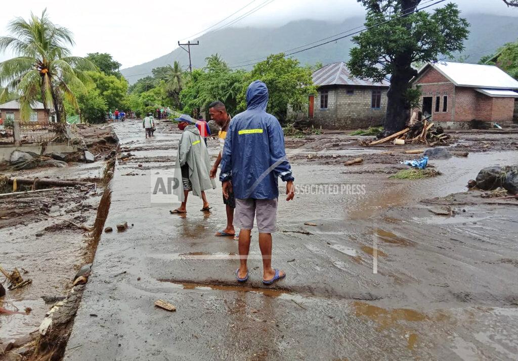 Ricko Wawo People inspect the damage at a village affected by flood in Ile Ape, on Lembata Island, East Nusa Tenggara province, Indonesia, Sunday, April 4, 2021. Multiple disasters caused by torrential rains in eastern Indonesia have left dozens of people dead or missing while displacing thousands, the country's disaster relief agency said Monday. (AP Photo/Ricko Wawo)
