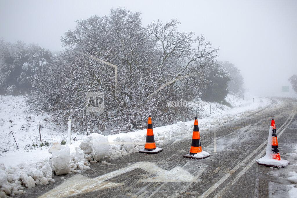 Ariel Schalit A road with snow is blocked near the Quneitra border crossing between Syria and the Israeli-controlled Golan Heights Wednesday, Feb. 17, 2021. (AP Photo/Ariel Schalit)