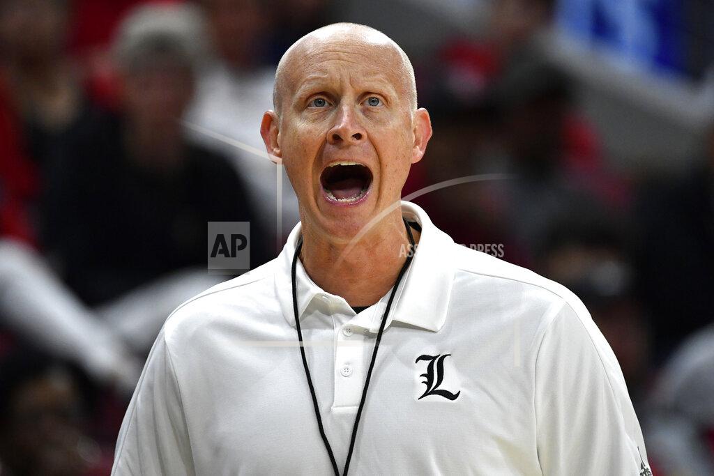 Timothy D. Easley FILE - In this Oct. 12, 2019, file photo, Louisville head coach Chris Mack instructs his team during an NCAA college basketball practice in Louisville, Ky. Louisville is back in the national championship conversation after the basketball program was knocked on its heels amid the fallout of embarrassing scandals, including the school’s missteps that were discovered in a federal investigation into college basketball and escorts performing in players’ dorm. In just his second year, Chris Mack has the Cardinals opening the season ranked in the Top 25. (AP Photo/Timothy D. Easley, File)