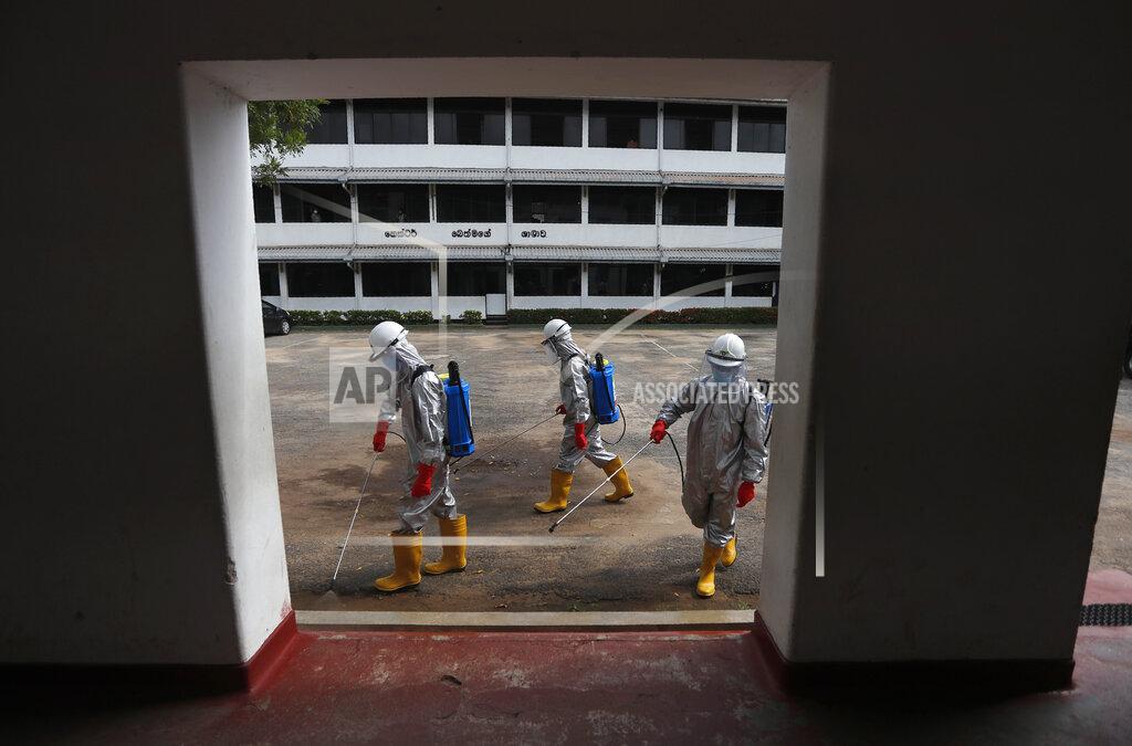 Eranga Jayawardena Members of Sri Lanka's St John's ambulance service spray disinfectants in a public school to prevent the spread of coronavirus in Colombo, Sri Lanka, Monday, June 22, 2020. (AP Photo/Eranga Jayawardena)