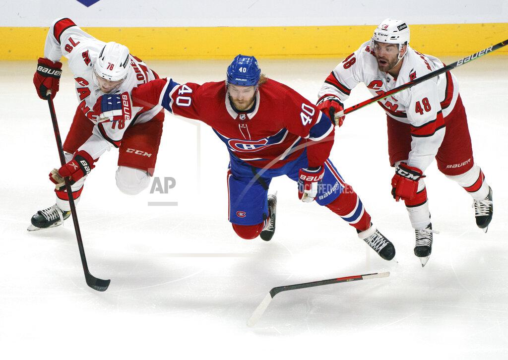 Paul Chiasson Montreal Canadiens' Joel Armia gets caught between Carolina Hurricanes' Steven Lorentz, left, and Jordan Martinook during the second period of an NHL hockey game Thursday, Oct. 21, 2021, in Montreal. (Paul Chiasson/The Canadian Press via AP)