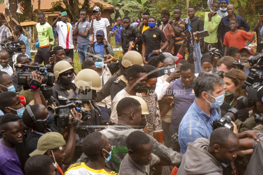 Jerome Delay Uganda's leading opposition challenger Bobi Wine and his wife, centre, leave the polling station after voting in Kampala, Uganda, Thursday, Jan. 14, 2021. Ugandans are voting in a presidential election tainted by widespread violence that some fear could escalate as security forces try to stop supporters of Wine from monitoring polling stations.(AP Photo/Jerome Delay)