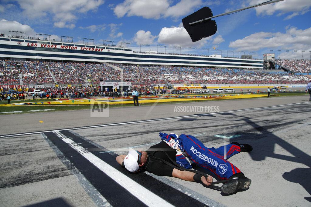 John Locher A member of Chris Buescher's pit crew stretches before a NASCAR Cup Series auto race at Las Vegas Motor Speedway, Sunday, March 3, 2019, in Las Vegas. (AP Photo/John Locher)