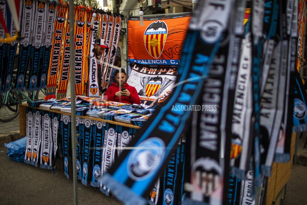 Emilio Morenatti A vendor waits for customers at his stall street outside Mestalla stadium, ahead of the Champions League round of 16 second leg soccer match between Valencia and Atalanta in Valencia, Spain, Tuesday March 10, 2020. The match will take place in an empty stadium because of the coronavirus outbreak. (AP Photo/Emilio Morenatti)