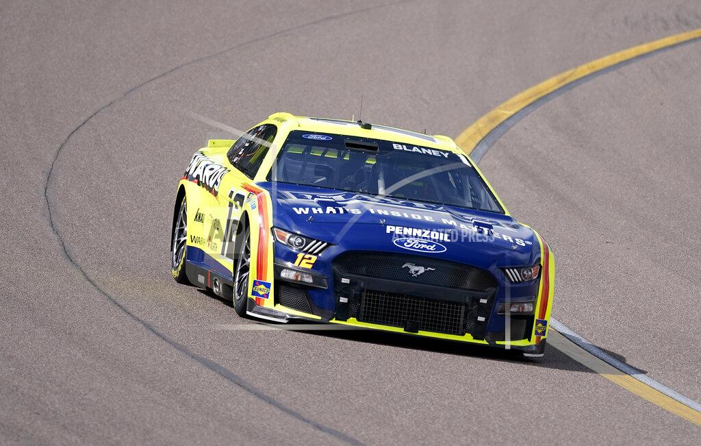 Darryl Webb Ryan Blaney (12) leads early in a NASCAR Cup Series auto race at Phoenix Raceway, Sunday, March 13, 2022, in Avondale, Ariz. (AP Photo/Darryl Webb)