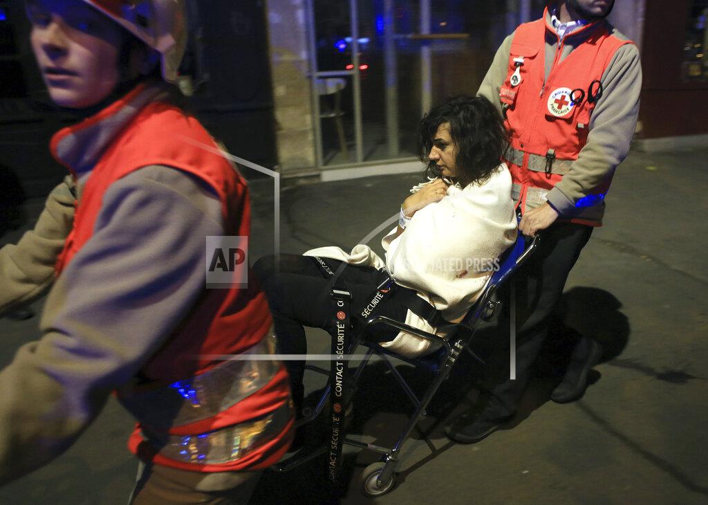 Thibault Camus FILE - In this Friday Nov. 13, 2015 file photo a woman is evacuated from the Bataclan theater after a shooting in Paris. (AP Photo/Thibault Camus, File)