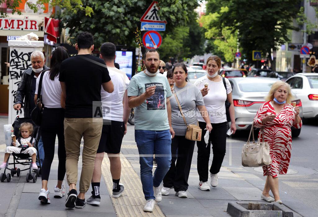Burhan Ozbilici People who are not wearing face masks to protect against the spread of coronavirus, walk in city the centre, in Ankara, Turkey, Sunday, June 21, 2020. Turkish authorities have made the wearing of masks mandatory in three major cities to curb the spread of COVID-19 following an uptick in confirmed cases since the reopening of many businesses.(AP Photo/Burhan Ozbilici)