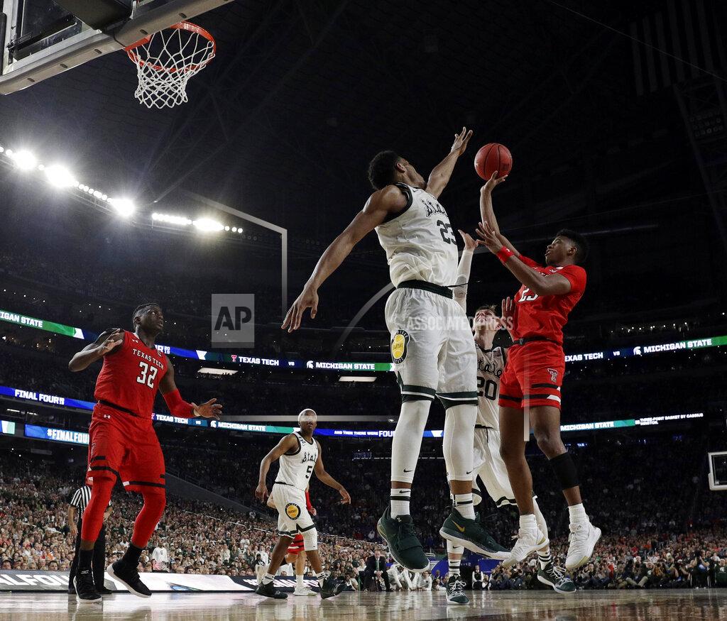 David J. Phillip Texas Tech's Jarrett Culver (23) takes a shot against Michigan State's Xavier Tillman (23) and Matt McQuaid (20) during the second half in the semifinals of the Final Four NCAA college basketball tournament, Saturday, April 6, 2019, in Minneapolis. (AP Photo/David J. Phillip)