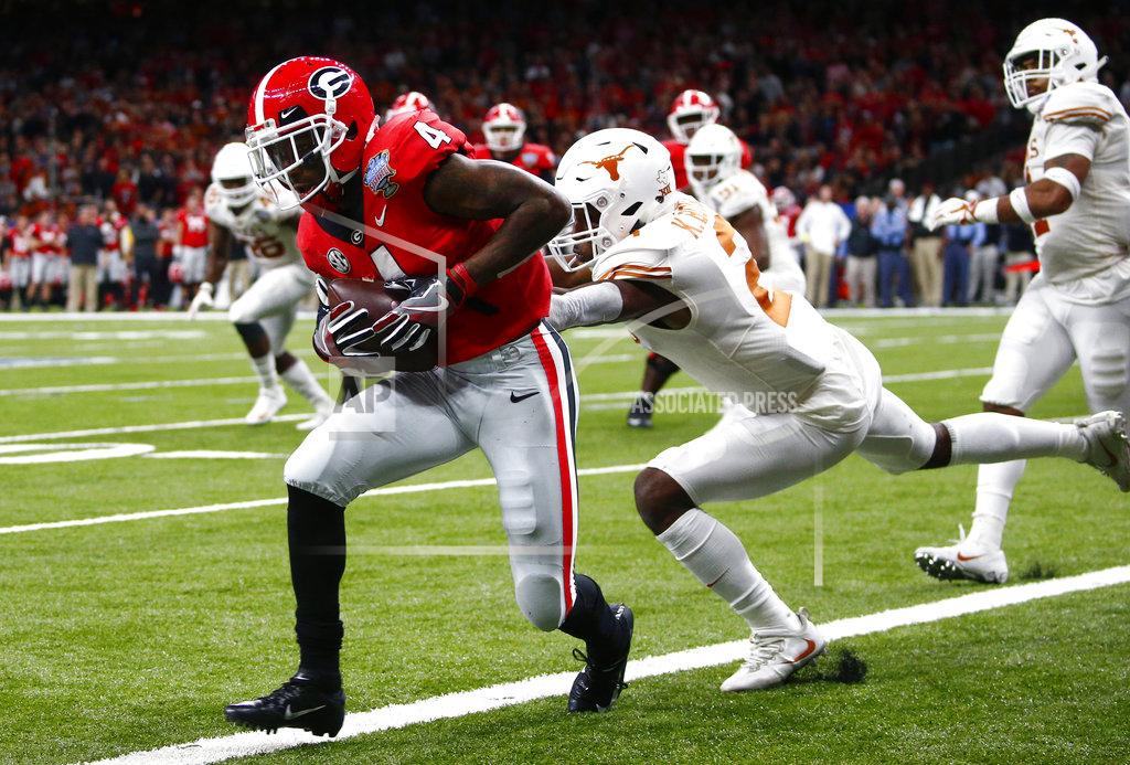 Butch Dill Georgia wide receiver Mecole Hardman (4) scores a touchdown against Texas defensive back Kris Boyd (2) during the second half of the Sugar Bowl NCAA college football game in New Orleans, Tuesday, Jan. 1, 2019. (AP Photo/Butch Dill)