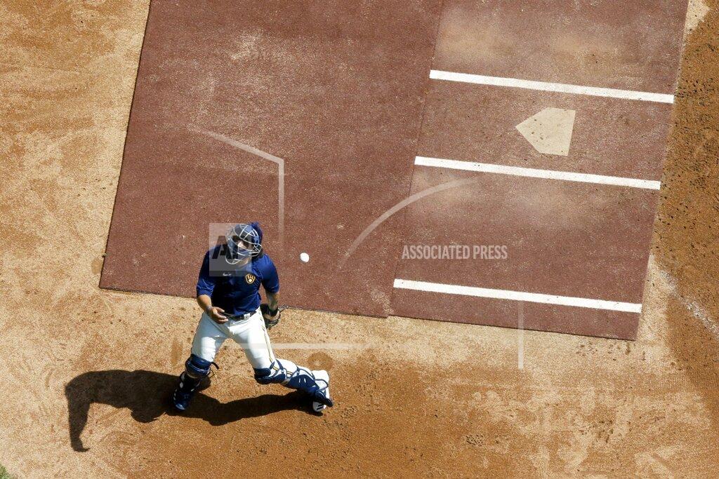 Morry Gash Milwaukee Brewers' Jacob Nottingham tries to catch a ball during a practice session Monday, July 13, 2020, at Miller Park in Milwaukee. (AP Photo/Morry Gash)
