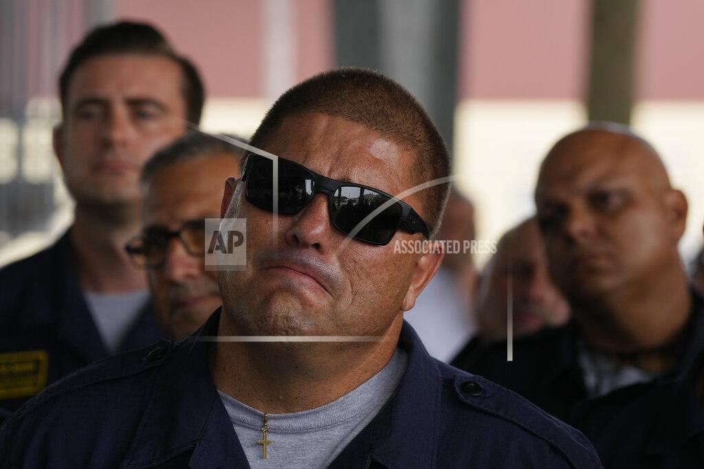 Rebecca Blackwell Members of Miami-Dade Fire Rescue's urban search and rescue team listen to officials lauding their efforts as they are welcomed back from a weeks-long deployment working on the rubble pile at the collapsed Champlain Towers South condominium, on Friday, July 23, 2021, in Doral, Fla. (AP Photo/Rebecca Blackwell)