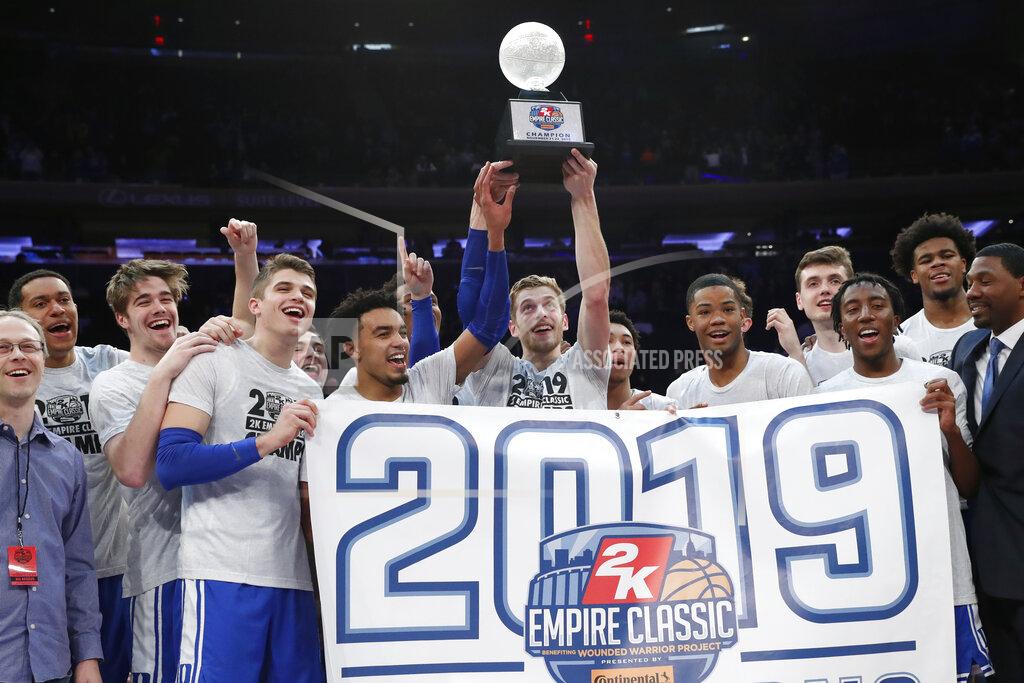 Kathy Willens Duke players celebrate with the trophy after defeating Georgetown 81-73 in an NCAA college basketball game for the 2K Empire Classic championship, Friday, Nov. 22, 2019 in New York. (AP Photo/Kathy Willens)