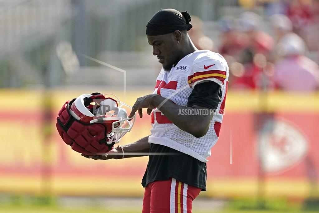 Kansas City Chiefs defensive back Frank Clark looks at his helmet during NFL football training camp Monday, Aug. 1, 2022, in St. Joseph, Mo. (AP Photo/Charlie Riedel)