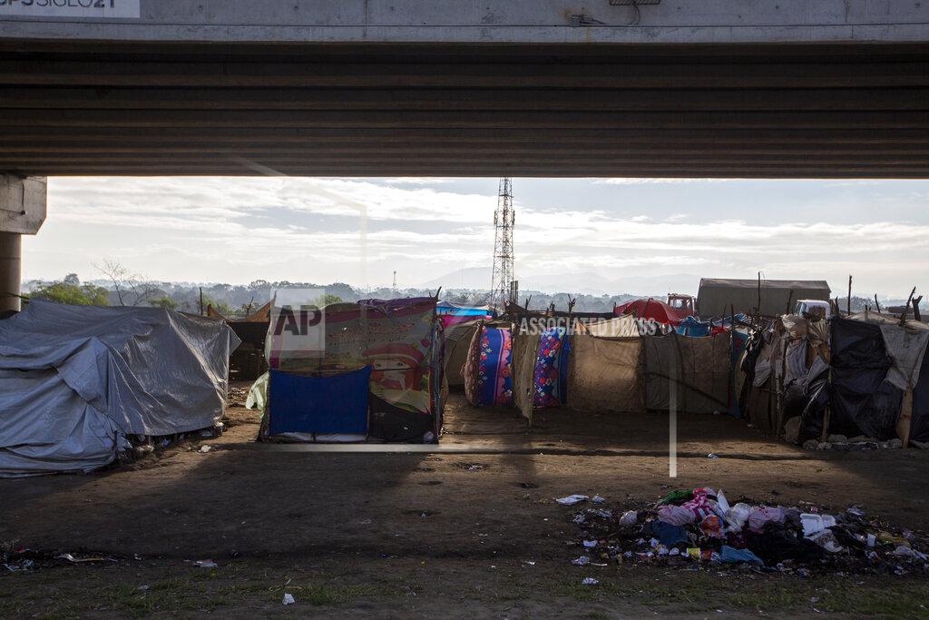 Moises Castillo People who lost their homes in last year's hurricanes Eta and Iota live under tarps they set up under a bridge on the outskirts of San Pedro Sula, Honduras, Monday, Jan. 11, 2021. President Joe Biden has promised investment in Central America to get at the root causes of immigration, but no one expects to see any change soon. (AP Photo/Moises Castillo)