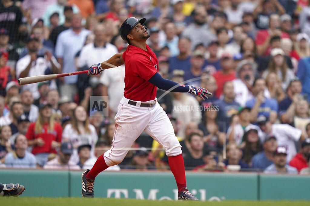 Steven Senne Boston Red Sox's Xander Bogaerts hits a sacrifice fly allowing Enrique Hernandez to score in the eighth inning of a baseball game against the New York Yankees, Sunday, July 25, 2021, in Boston. The Red Sox won 5-4. (AP Photo/Steven Senne)