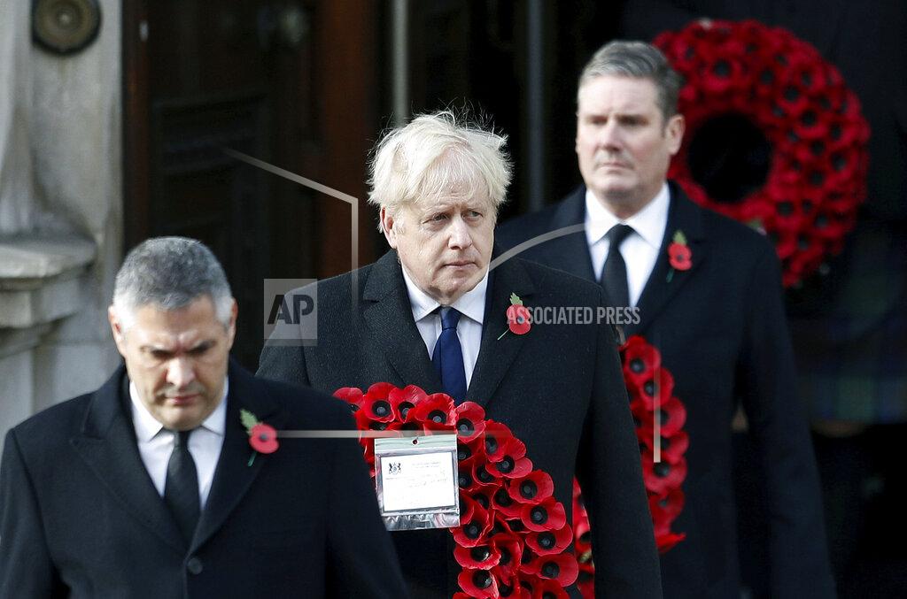 Peter Nicholls Britian's Prime Minister Boris Johnson carries a wreath, during the Remembrance Sunday service at the Cenotaph, in Whitehall, London, Sunday Nov. 8, 2020. (Peter Nicholls/Pool Photo via AP)