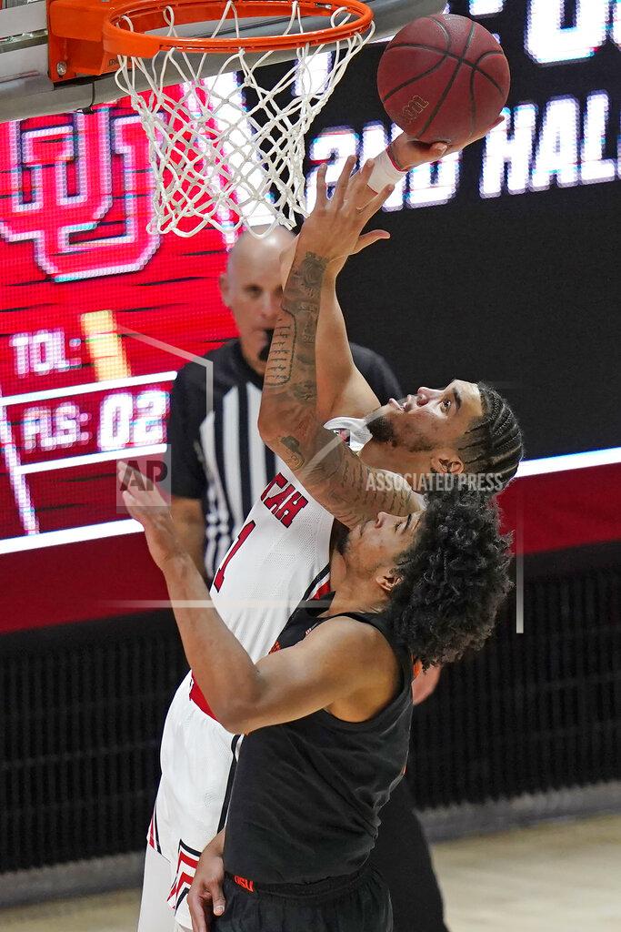 Rick Bowmer Utah forward Timmy Allen (1) shoots as Oregon State guard Ethan Thompson, foreground, defends during the second half during an NCAA college basketball game Wednesday, March 3, 2021, in Salt Lake City. (AP Photo/Rick Bowmer)