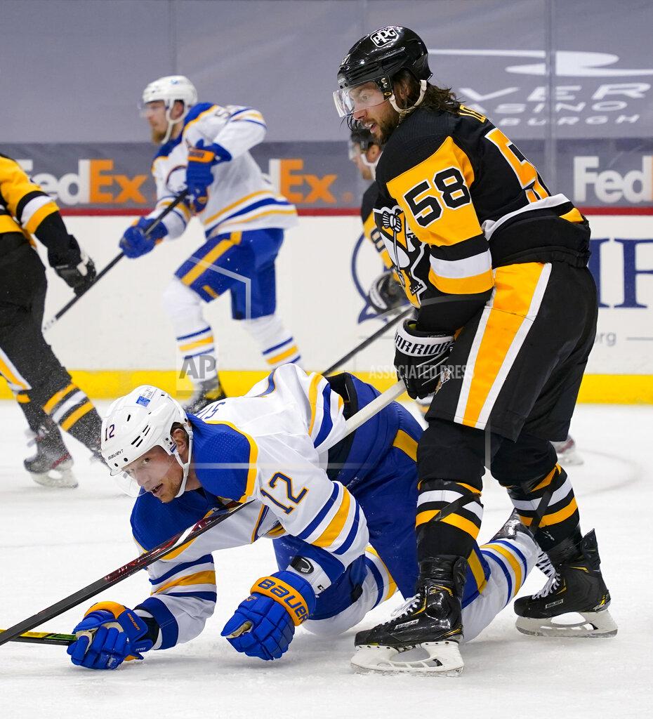 Keith Srakocic Pittsburgh Penguins' Kris Letang (58) tries to keep Buffalo Sabres' Eric Staal (12) on the ice during the second period of an NHL hockey game Thursday, March 25, 2021, in Pittsburgh. (AP Photo/Keith Srakocic)