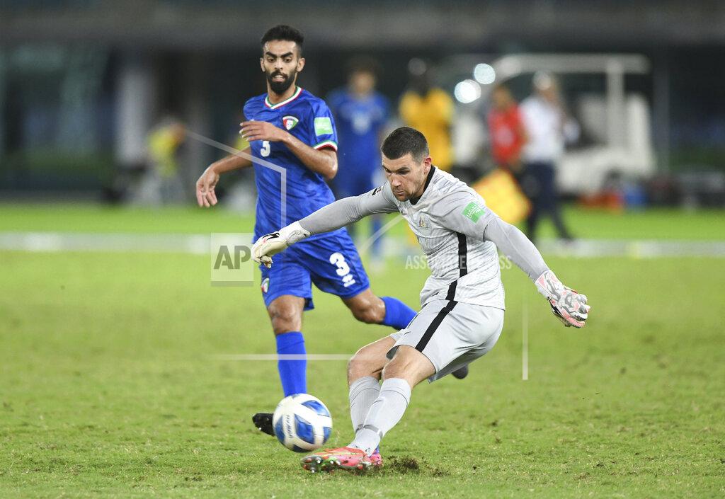 Jaber Abdulkhaleg Australia's goalkeeper Mathew Ryan, right, clears the ball past Kuwait's Ahmad Aldhefiri during the World Cup 2022 Group B qualifying soccer match between Kuwait and Australia in Kuwait City, Kuwait, Thursday, June 3, 2021. (AP Photo/Jaber Abdulkhaleg)
