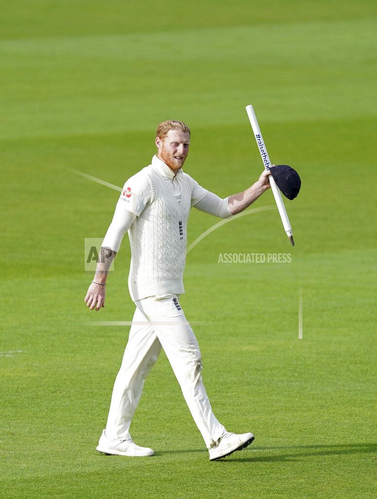 England's Ben Stokes walks off the field carrying a stump after their win on the last day of the second cricket Test match between England and West Indies at Old Trafford in Manchester, England, Monday, July 20, 2020. (AP Photo/Jon Super, Pool)