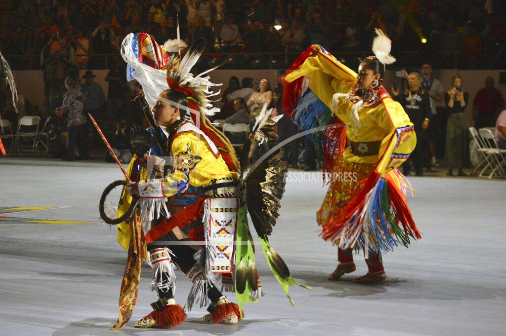 Russell Contreras FILE - In this April 27, 2018, file photo, dancers enter at the Gathering of Nations, one of the world's largest gatherings of Indigenous people in Albuquerque, N.M. This year’s Gathering of Nations is taking place virtually this week as the coronavirus pandemic causes powwows across the U.S. to adapt for a second year. (AP Photo/ Russell Contreras, File)