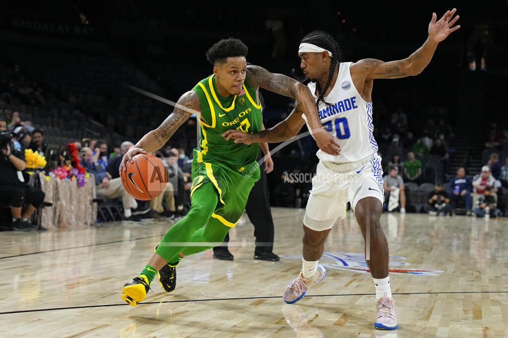 Rick Scuteri Oregon guard Jacob Young drives against Chaminade guard Raazhel Watkins (20) in the first half during an NCAA college basketball game at the Maui Invitational in Las Vegas, Monday, Nov. 22, 2021. (AP Photo/Rick Scuteri)