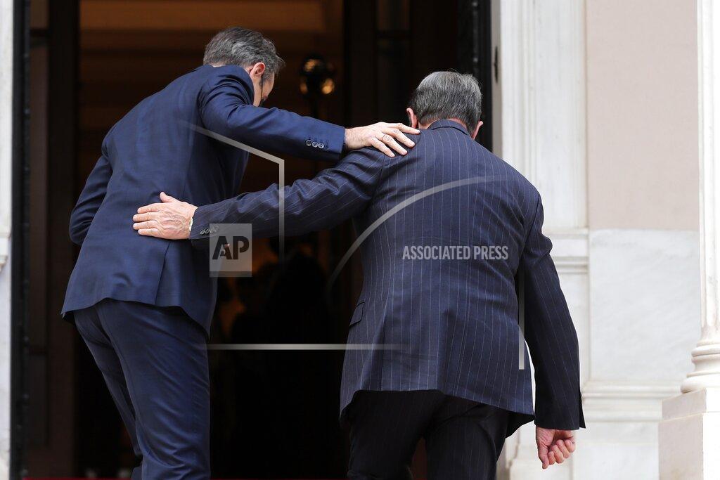 Petros Giannakouris Greece's Prime Minister Kyriakos Mitsotakis, left, welcomes Cypriot President Nicos Anastasiades at Maximos Mansion in Athens, Wednesday, March 24, 2021. The military parade on March 25, marking 200-years since the war that resulted in Greece's independence from the Ottoman Empire and rebirth as a nation, will be held without spectators due to the coronavirus, and only Greek and foreigners political officials. (AP Photo/Petros Giannakouris)