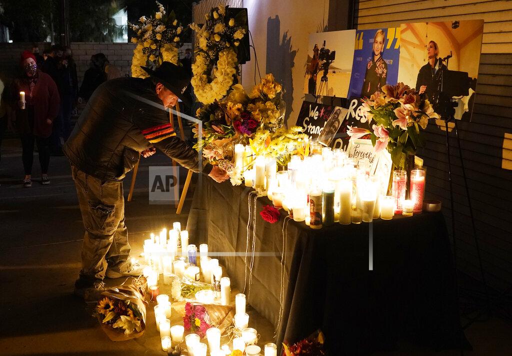 Chris Pizzello Russ Backers, a stagehand and welder in IATSE Local 33, lays down his union pin for the late cinematographer Halyna Hutchins during a candlelight vigil for her, Sunday, Oct. 24, 2021, in Burbank, Calif. A prop firearm discharged last Thursday by actor Alec Baldwin, while producing and starring in a Western movie in Santa Fe, N.M., killed Hutchins and wounded director Joel Souza. (AP Photo/Chris Pizzello)