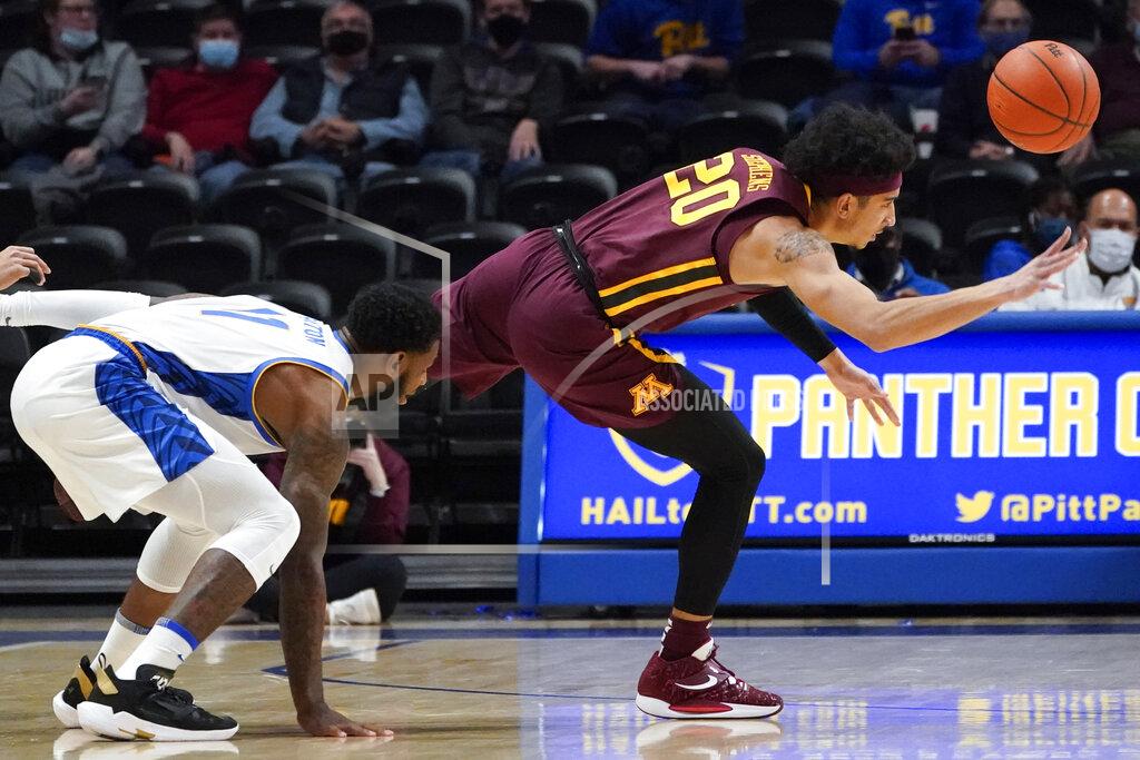 Keith Srakocic Minnesota's E.J. Stephens (20) tries to get a pass away as Pittsburgh's Jamarius Burton, left, defends during the first half of an NCAA college basketball game Tuesday, Nov. 30, 2021, in Pittsburgh. (AP Photo/Keith Srakocic)