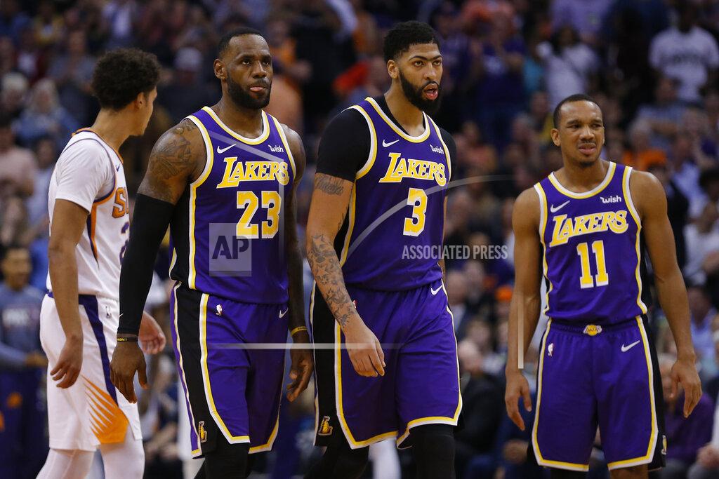 Rick Scuteri FILE- In this Nov. 12, 2019 file photo, Angeles Lakers forward LeBron James (23) and Anthony Davis (3) look on during the first half during an NBA basketball game against the Phoenix Suns in Phoenix. Davis’ status is uncertain with the restart of the NBA season looming. Davis, who left the Los Angeles Lakers’ second scrimmage after getting poked in the eye and didn’t play in the team’s exhibition finale at Walt Disney World, didn’t practice on Tuesday, July 28, 2020. (AP Photo/Rick Scuteri, File)