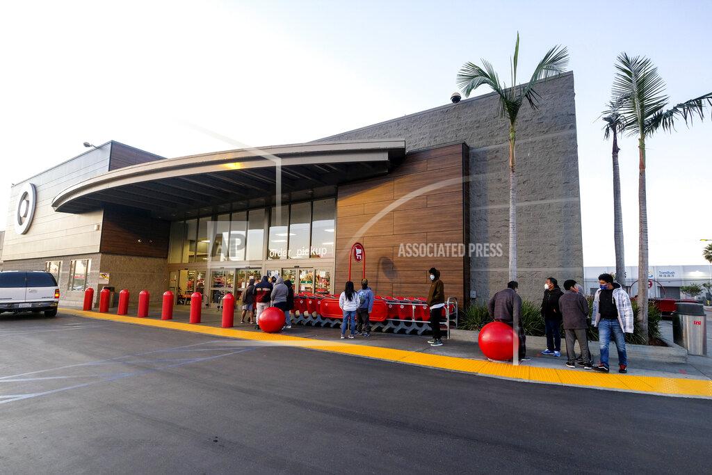 Ringo H.w. Chiu A few Black Friday shoppers wait in line to enter a Target store that opened at 7am in Commerce, Calif., Friday, Nov. 27, 2020. (AP Photo/Ringo H.W. Chiu)