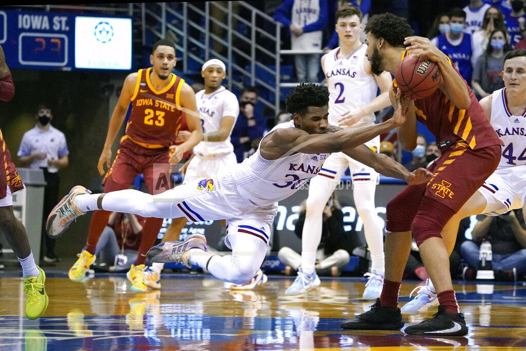 Ed Zurga Kansas' Ochai Agbaji (30) dives as he tries to steal the ball from Iowa State's George Conditt IV (4) in the first half of an NCAA college basketball game Tuesday, Jan. 11, 2022, in Lawrence, Kan. (AP Photo/Ed Zurga)