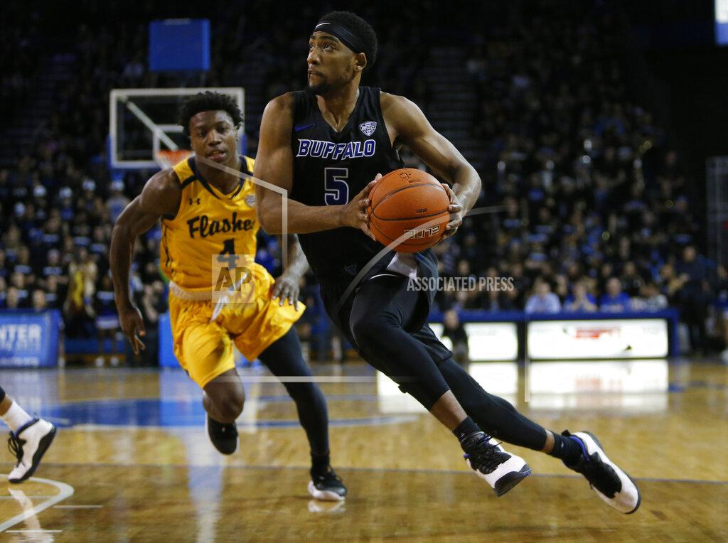 Jeffrey T. Barnes Buffalo guard CJ Massinburg (5) drives past Kent State guard Antonio Williams (4) during the second half of an NCAA college basketball game, Friday, Feb. 22, 2019, in Buffalo, N.Y. (AP Photo/Jeffrey T. Barnes)