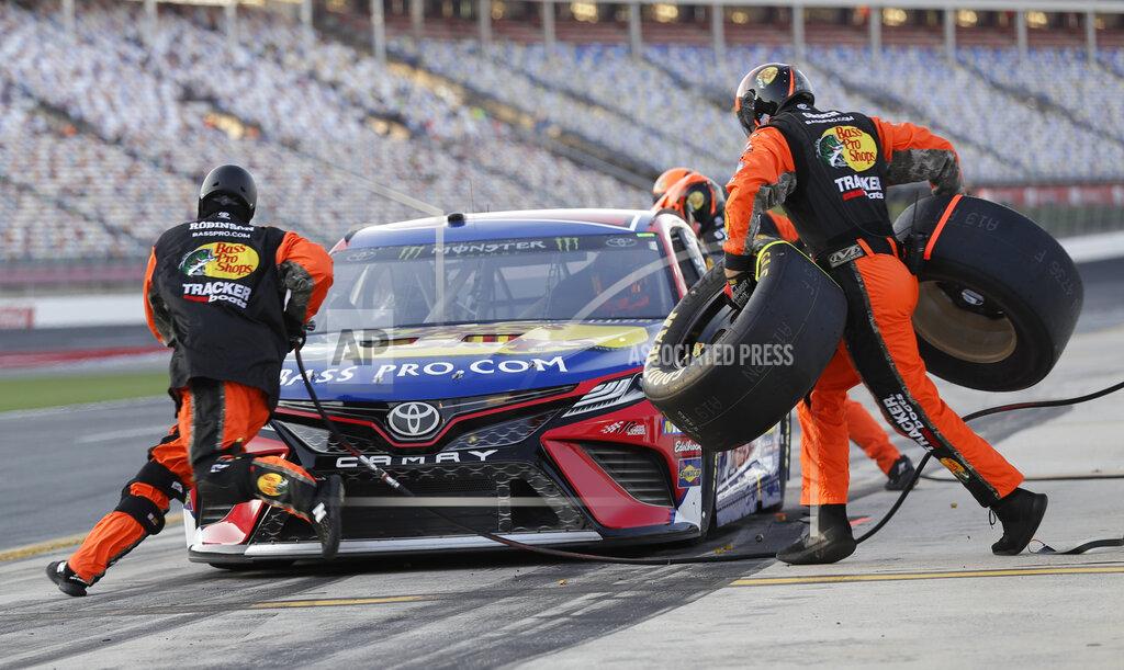 Chuck Burton Crew members perform a pit stop on driver Martin Truex Jr's car during qualifying for Saturday's NASCAR All-Star Cup series auto race at Charlotte Motor Speedway in Concord, N.C., Friday, May 17, 2019. (AP Photo/Chuck Burton)