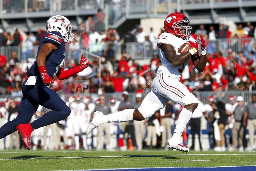 Tim Warner In this Dec. 7, 2019 photo, North Shore Mustangs running back Zachary Evans (3) rushes for a touchdown chased by Atascocita Eagles Daniel Onwuachi (4) during the first half of the high school football playoff game at Sheldon ISD Panther Stadium in Houston, Texas. The talented running back from Houston quietly signed with Georgia in December, but was later released from his national letter of intent by the Bulldogs. (Tim Warner/Houston Chronicle via AP)
