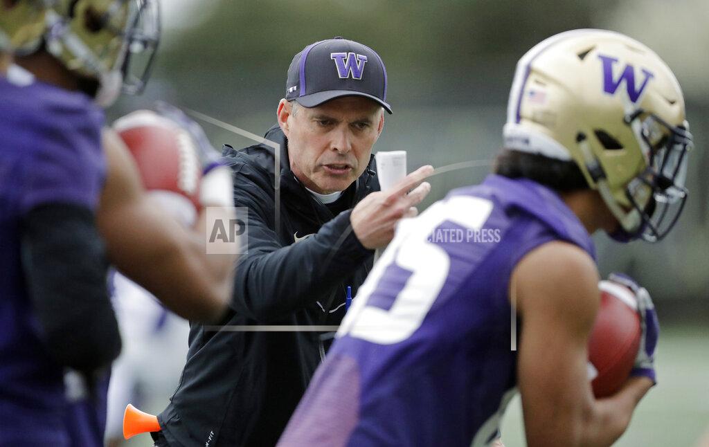 Ted S. Warren Washington head coach Chris Petersen talks to players as they run drill during the first day of spring NCAA college football practice, Wednesday, April 3, 2019, in Seattle. (AP Photo/Ted S. Warren)