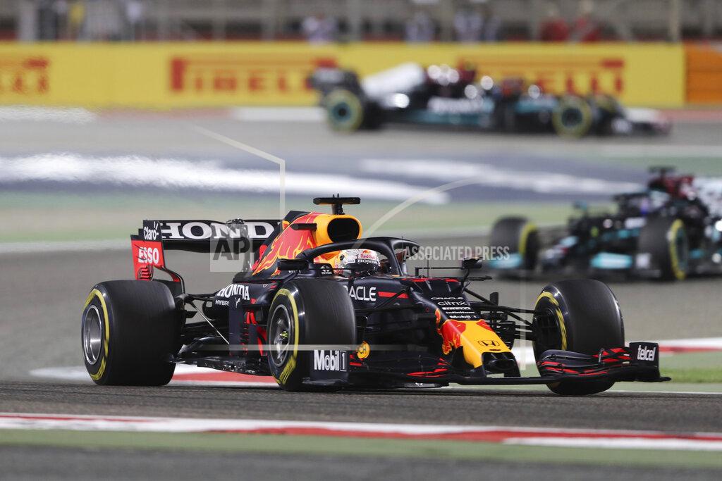 Kamran Jebreili Red Bull driver Max Verstappen of the Netherlands followed by Mercedes driver Lewis Hamilton of Britain steers his car during the Bahrain Formula One Grand Prix at the Bahrain International Circuit in Sakhir, Bahrain, Sunday, March 28, 2021. (AP Photo/Kamran Jebreili)