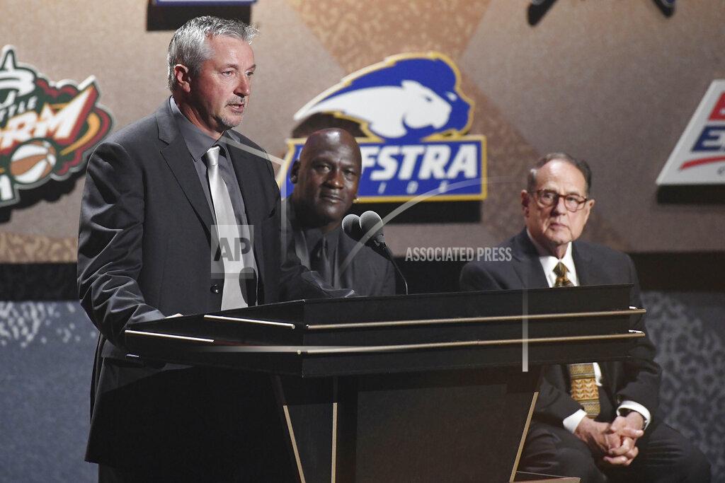 Jessica Hill Inductee Toni Kukoc, left, speaks as teammate Michael Jordan and Jerry Reinsdorf, listen during the 2021 Basketball Hall of Fame Enshrinement ceremony, Saturday, Sept. 11, 2021, in Springfield, Mass. (AP Photo/Jessica Hill)