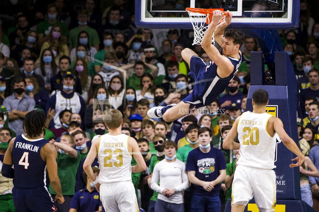 Robert Franklin Virginia's Francisco Caffaro (22) hangs on the rim after a dunk during the second half of an NCAA college basketball game against Notre Dame on Saturday, Jan. 29, 2022, in South Bend, Ind. (AP Photo/Robert Franklin)