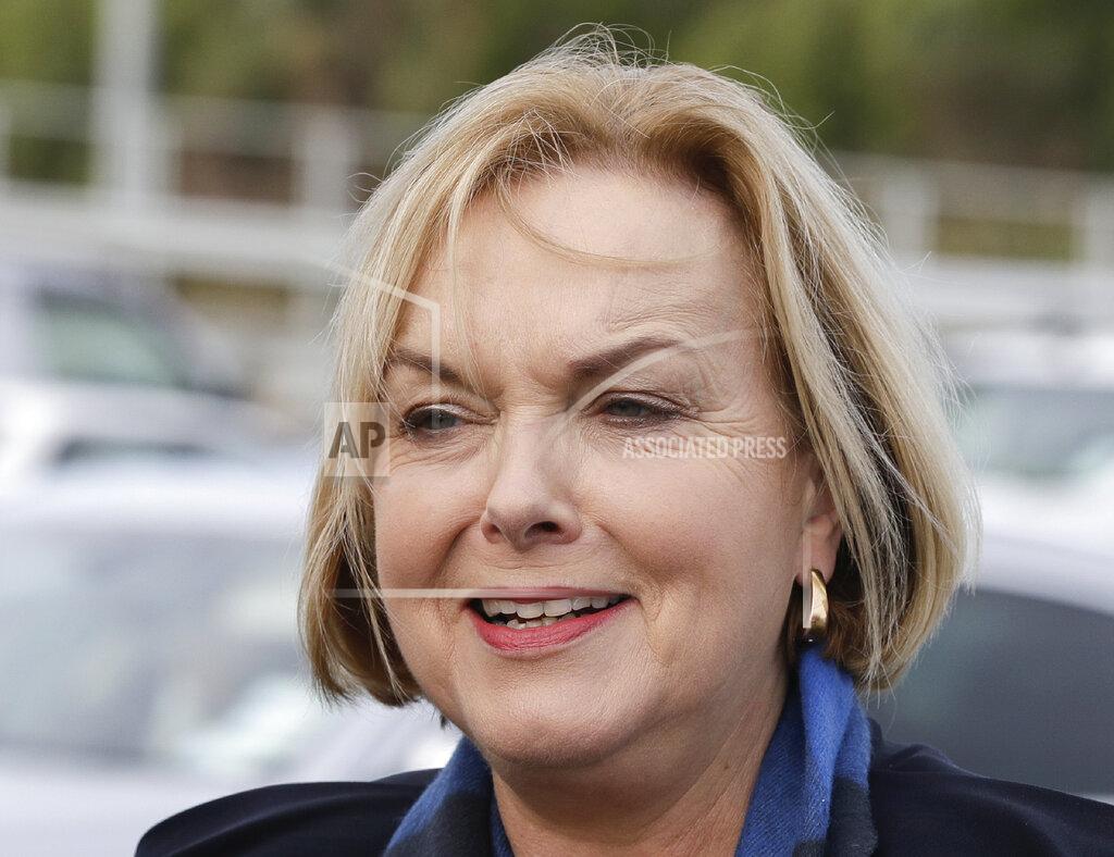 Mark Baker FILE - In this July 30, 2020, file photo, New Zealand opposition National Party leader Judith Collins arrives at a salmon factory in Christchurch, New Zealand. New Zealand has suffered a steep economic downturn due to the virus and is borrowing billions of dollars to try and stem job losses and rebuild. National is promising to increase infrastructure spending. (AP Photo/Mark Baker, File)