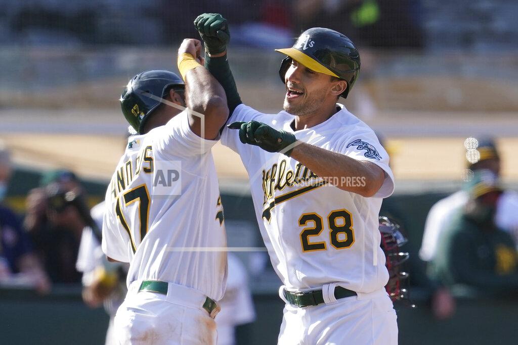 Jeff Chiu Oakland Athletics' Matt Olson (28) is congratulated by Elvis Andrus after hitting a grand slam home run against the Minnesota Twins during the fourth inning of the first baseball game of a doubleheader in Oakland, Calif., Tuesday, April 20, 2021. (AP Photo/Jeff Chiu)