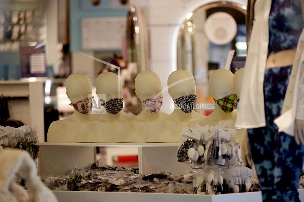 Matt Dunham Mannequin heads are seen through the front window displaying face masks inside the temporarily closed Topshop flagship store on Oxford Street, during England's second coronavirus lockdown, in London, Monday, Nov. 30, 2020. Arcadia Group, the retail empire of tycoon Philip Green, which owns well-known British fashion chains like Topshop and employs around 15,000 people, appears to be on the brink of collapse following the economic shock of the coronavirus pandemic. (AP Photo/Matt Dunham)