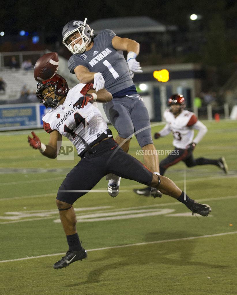 Tom R. Smedes San Diego State's Tariq Thompson (14) breaks up a pass to Nevada's McLane Mannix (1) in the second half of an NCAA college football game in Reno, Nev., Saturday, Oct. 27, 2018. (AP Photo/Tom R. Smedes)