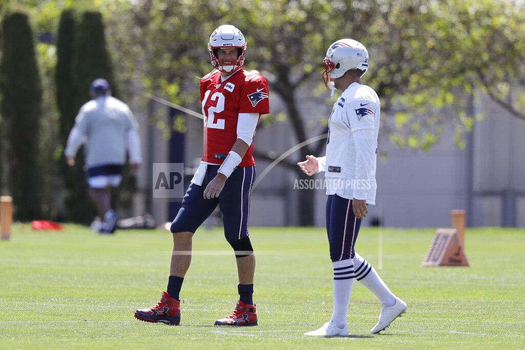 Steven Senne New England Patriots quarterback Tom Brady (12) speaks with kicker Stephen Gostkowski while warming up during an NFL football practice, Monday, Aug. 26, 2019, in Foxborough, Mass. (AP Photo/Steven Senne)
