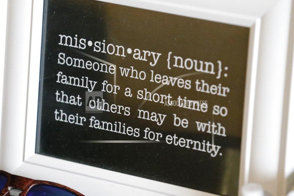Rick Bowmer In this May 27, 2020, photo, a framed definition of missionary sits on a desk at the apartment of missionaries with The Church of Jesus Christ of Latter-day Saints, in Brigham City, Utah. After hastily bringing home 26,000 young men and women who were serving in foreign countries, the faith has begun sending many of them out again in their home countries with a new focus on online work that could stick even when the pandemic is over, church officials told The Associated Press. (AP Photo/Rick Bowmer)