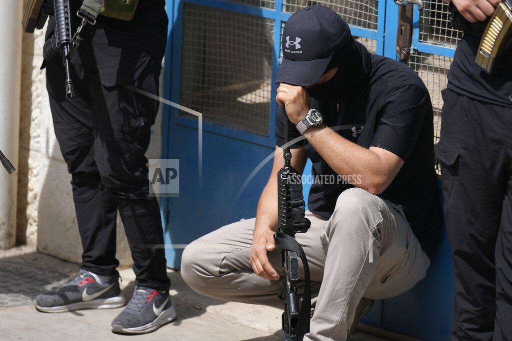 Majdi Mohammed Armed Palestinians mourn during the funeral of Amjad al-Fayyed, 17, in the West Bank refugee camp of Jenin, Saturday, May 21, 2022. Israeli troops shot and killed al-Fayyed as fighting erupted when soldiers entered a volatile town in the occupied West Bank early Saturday, the Palestinian health ministry and local media said. (AP Photo/Majdi Mohammed)