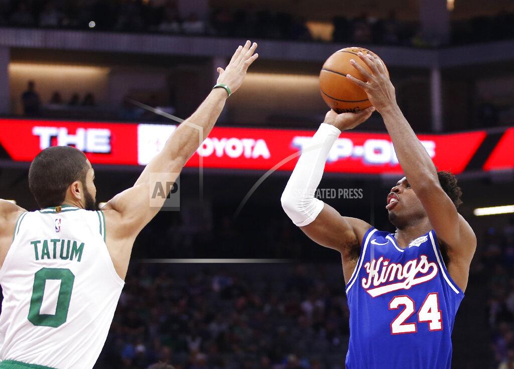 Boston Celtics forward Jayson Tatum, left, challenges the shoot of Sacramento Kings guard Buddy Hield, right, during the first half of an NBA basketball game in Sacramento, Calif., Sunday, Nov. 17, 2019. (AP Photo/Rich Pedroncelli)